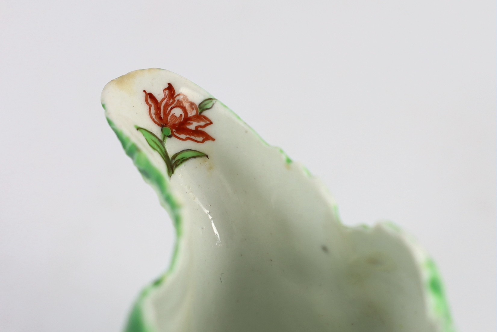 A Longton Hall cream jug, c.1755, 12.5cm long 8.1 cm high, hairline cracks